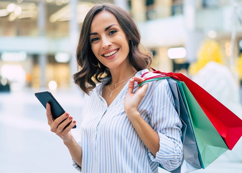woman-shopping-bags-phone-810x580